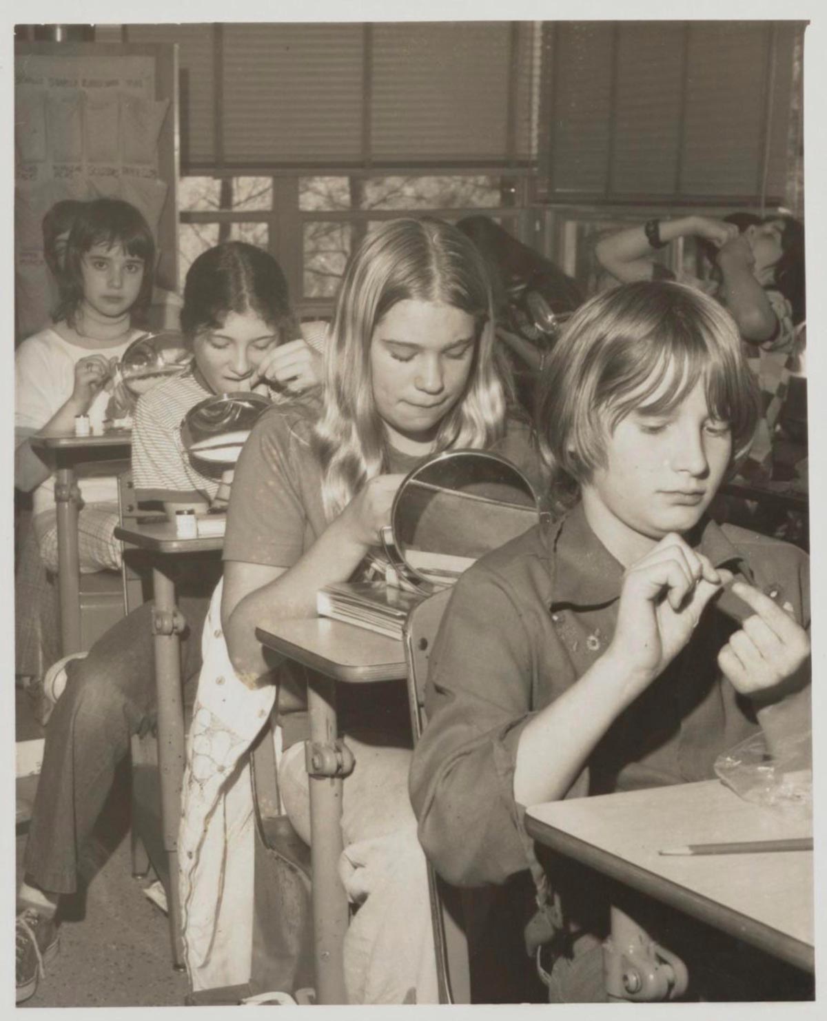 Black and white photo of students learning to floss
