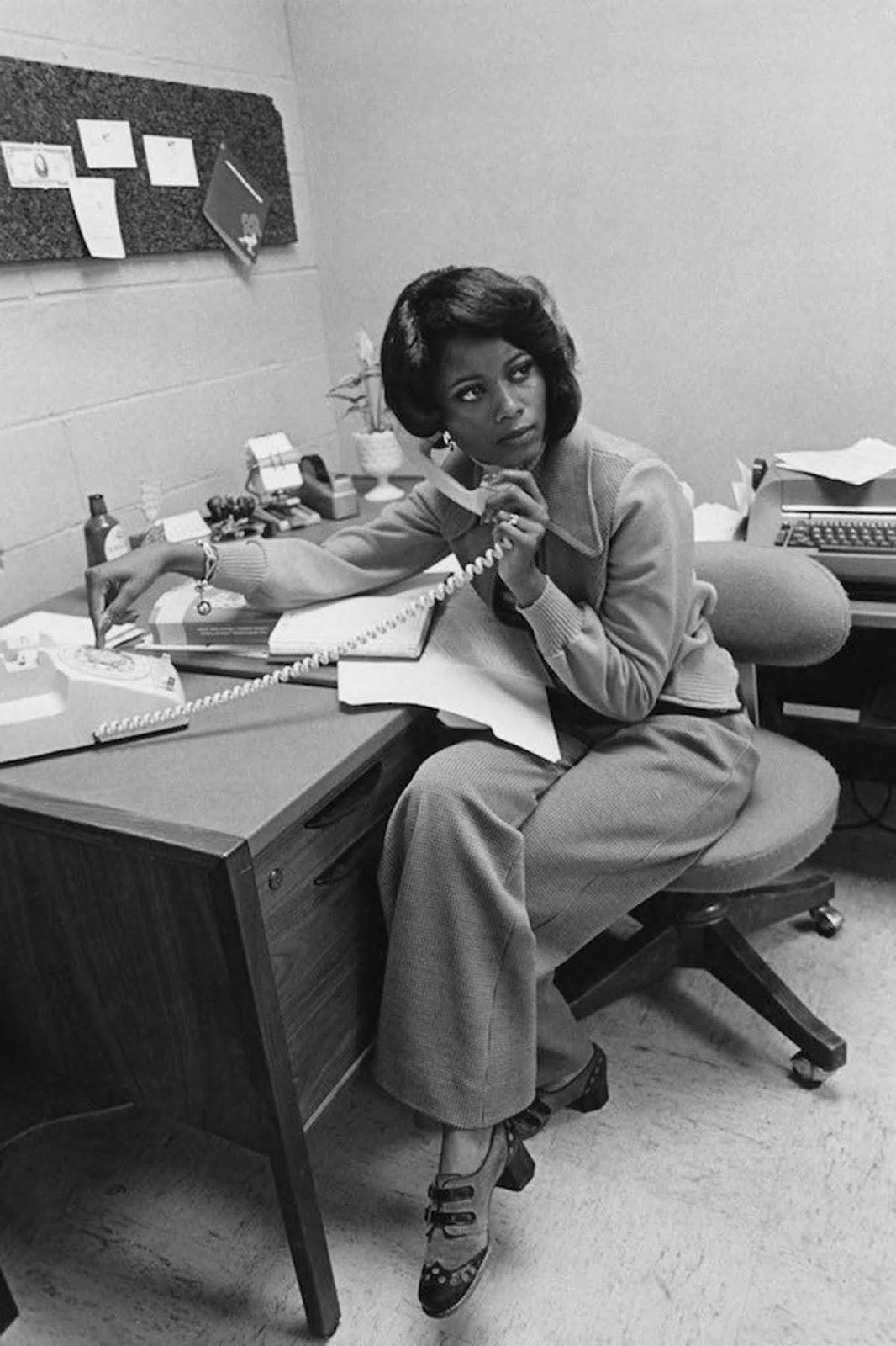 A woman on the phone at an office in the 1970s