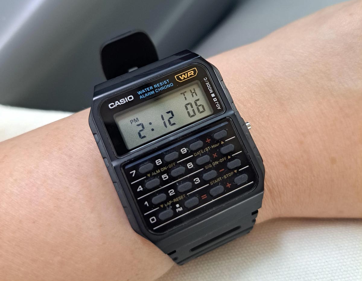 A casio calculator watch on a wrist