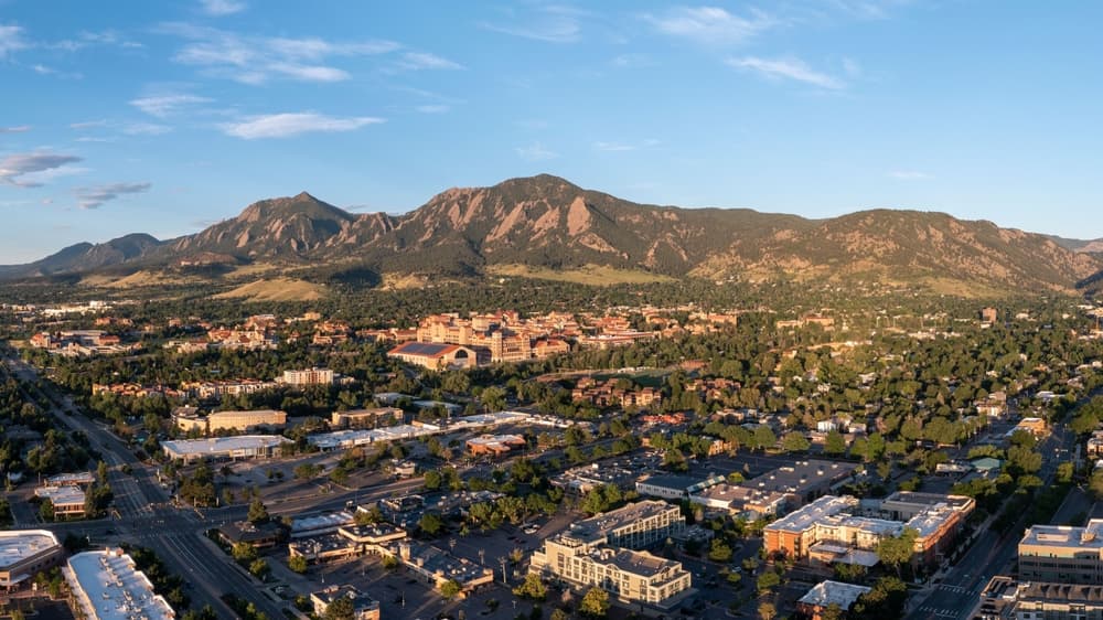 Morning sunrise photo of Boulder, Colorado  Highlights the city with a contrast on the mountains 