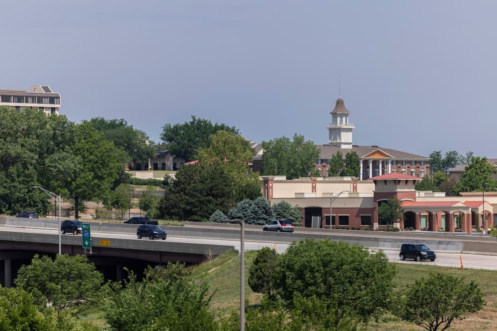Overland Park, Kansas, USA - June 17, 2023: Morning traffic passes through the downtown commercial district of Overland Park.