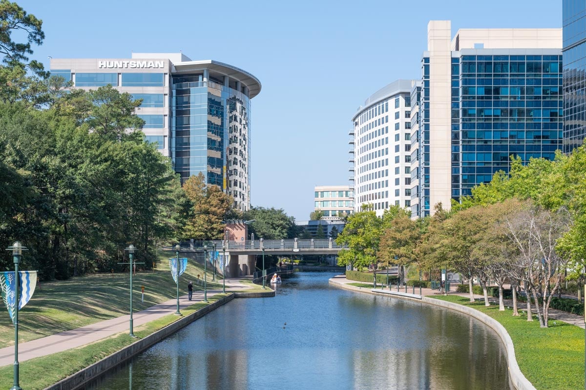 A river winding its way through the business district of an urban community.