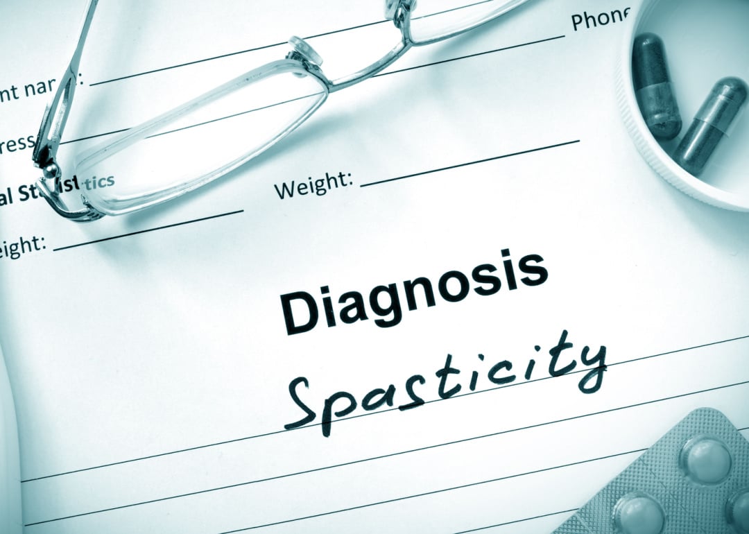 Diagnosis listed as spasticity on medical form.