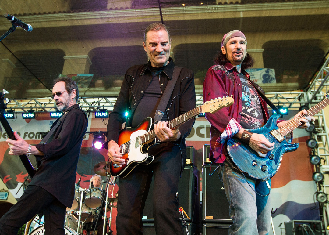 Mel Schacher, Max Carl, and Bruce Kulick perform in 2014.