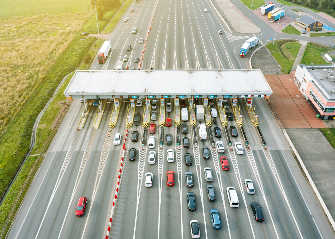 An overhead view of a busy toll booth on a highway.