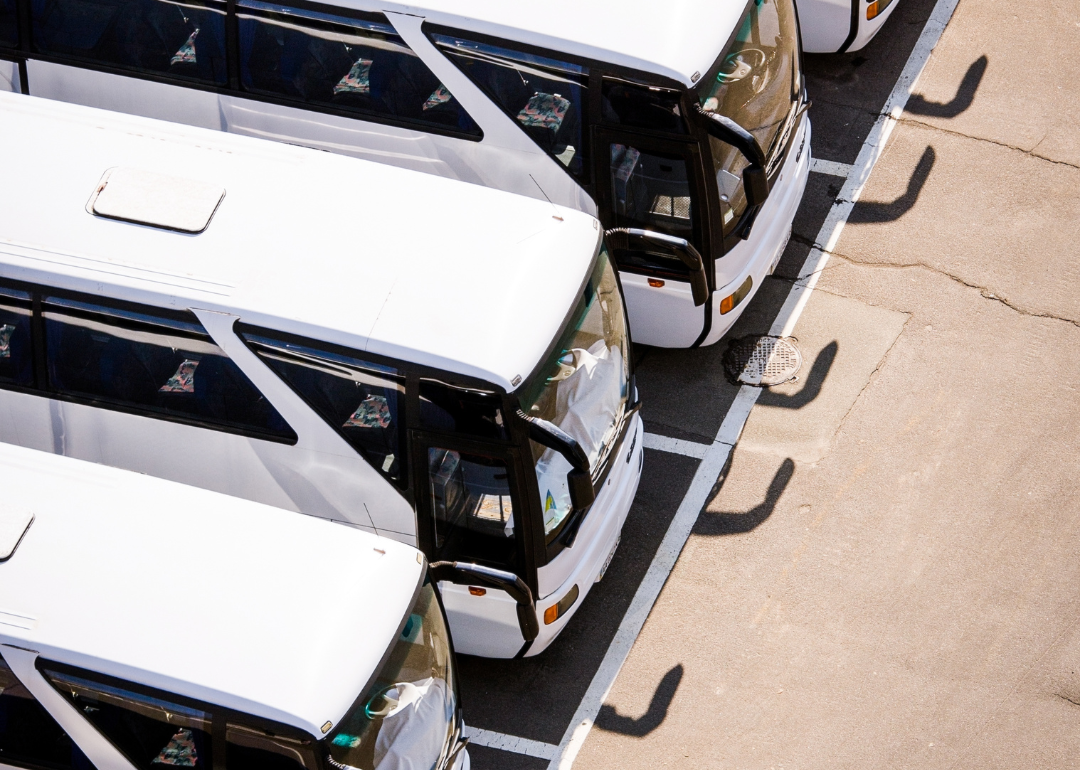 An overhead view of a row of charter buses.