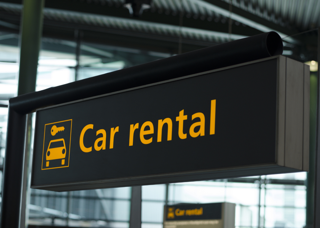 An airport sign directing people to car rentals.