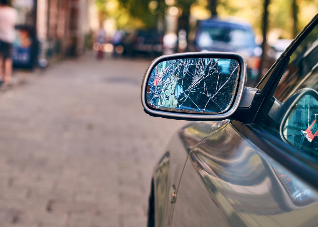 A car with a broken car door mirror.