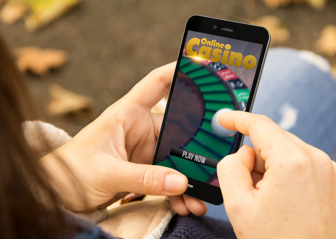 A person opening an online casino app on their phone.