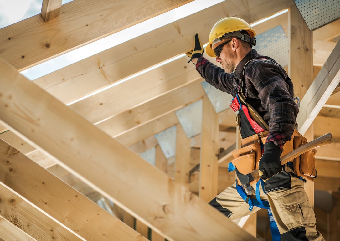 Construction worker on duty standing on wooden frame.
