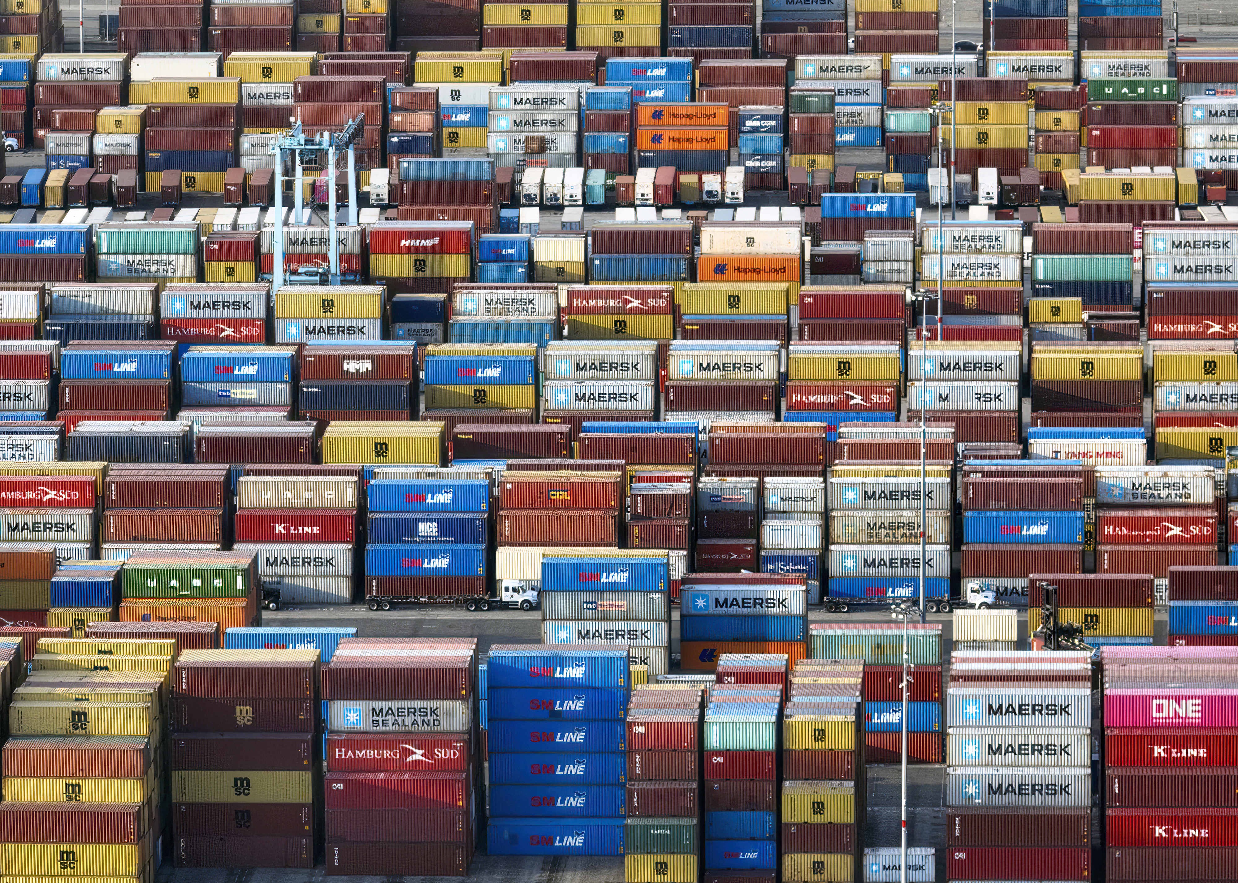 A backlog of containers are stacked at a port.