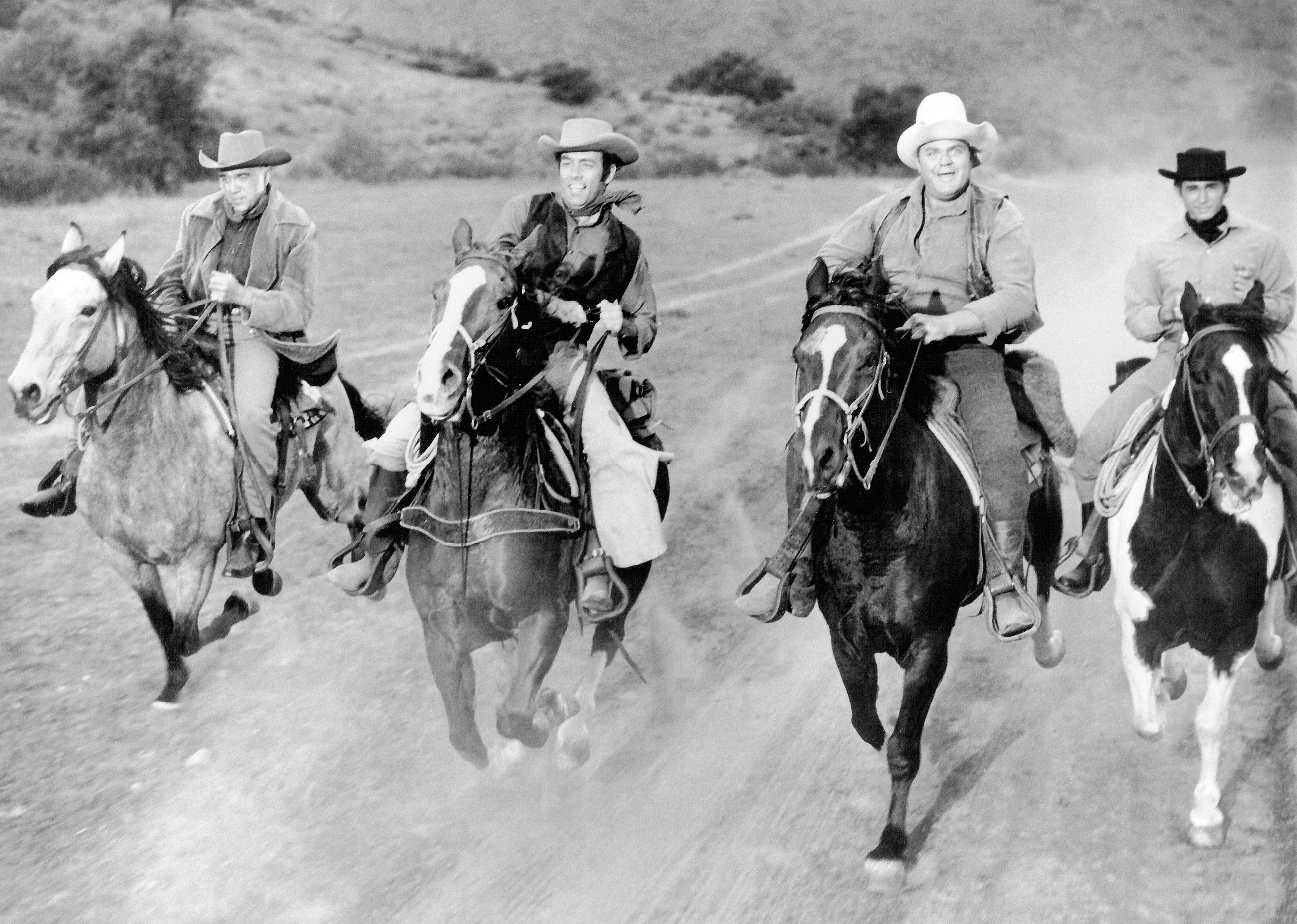 Members of the cast of the TV western series 'Bonanza' on horseback.