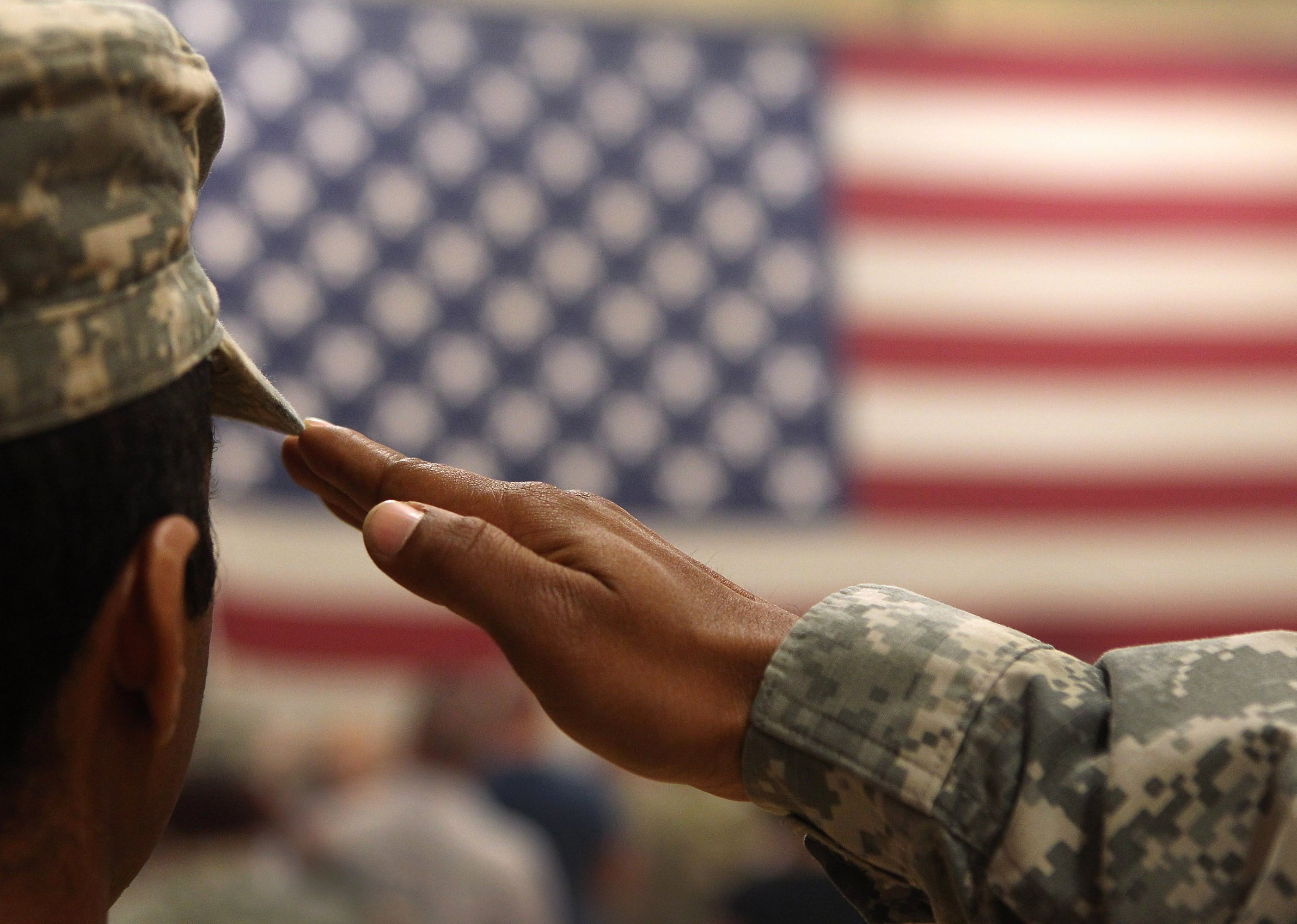  A soldier salutes the flag during a welcome home ceremony for troops arriving from Afghanistan.