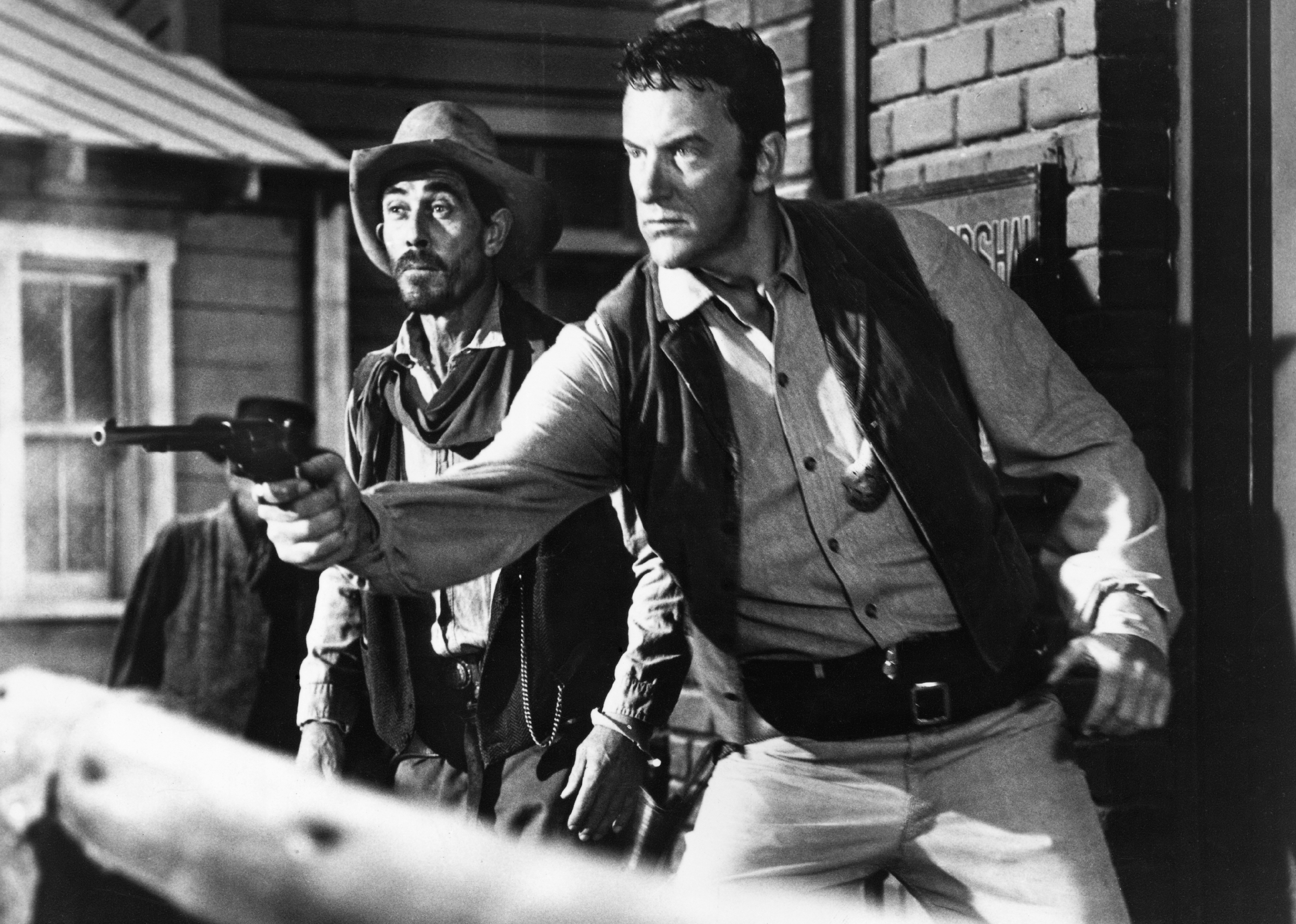 Television still from CBS series Gunsmoke, with Ken Curtis and James Arness.