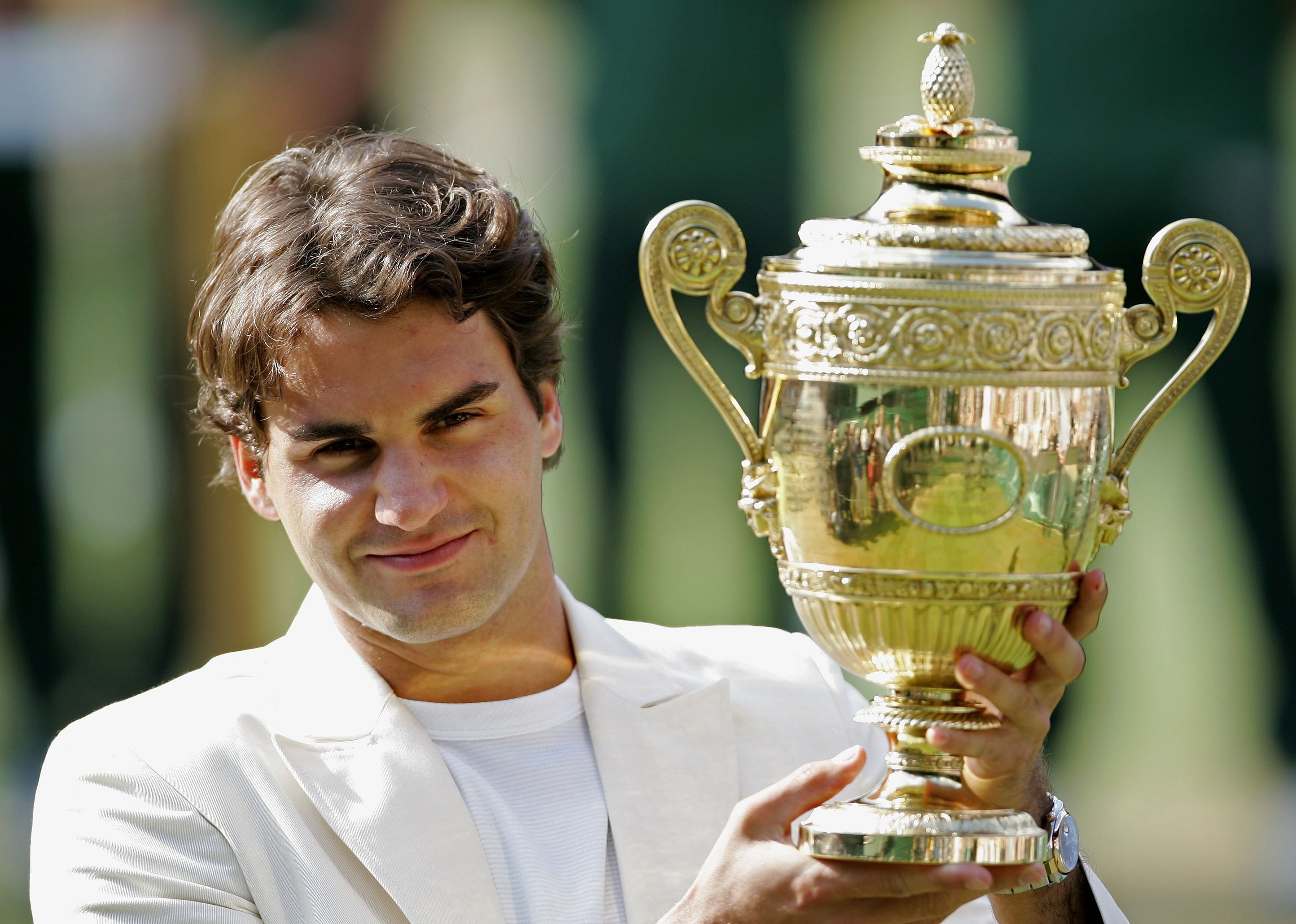 Roger Federer holds the trophy after winning the 2006 Wimbledon Lawn Tennis Championship.