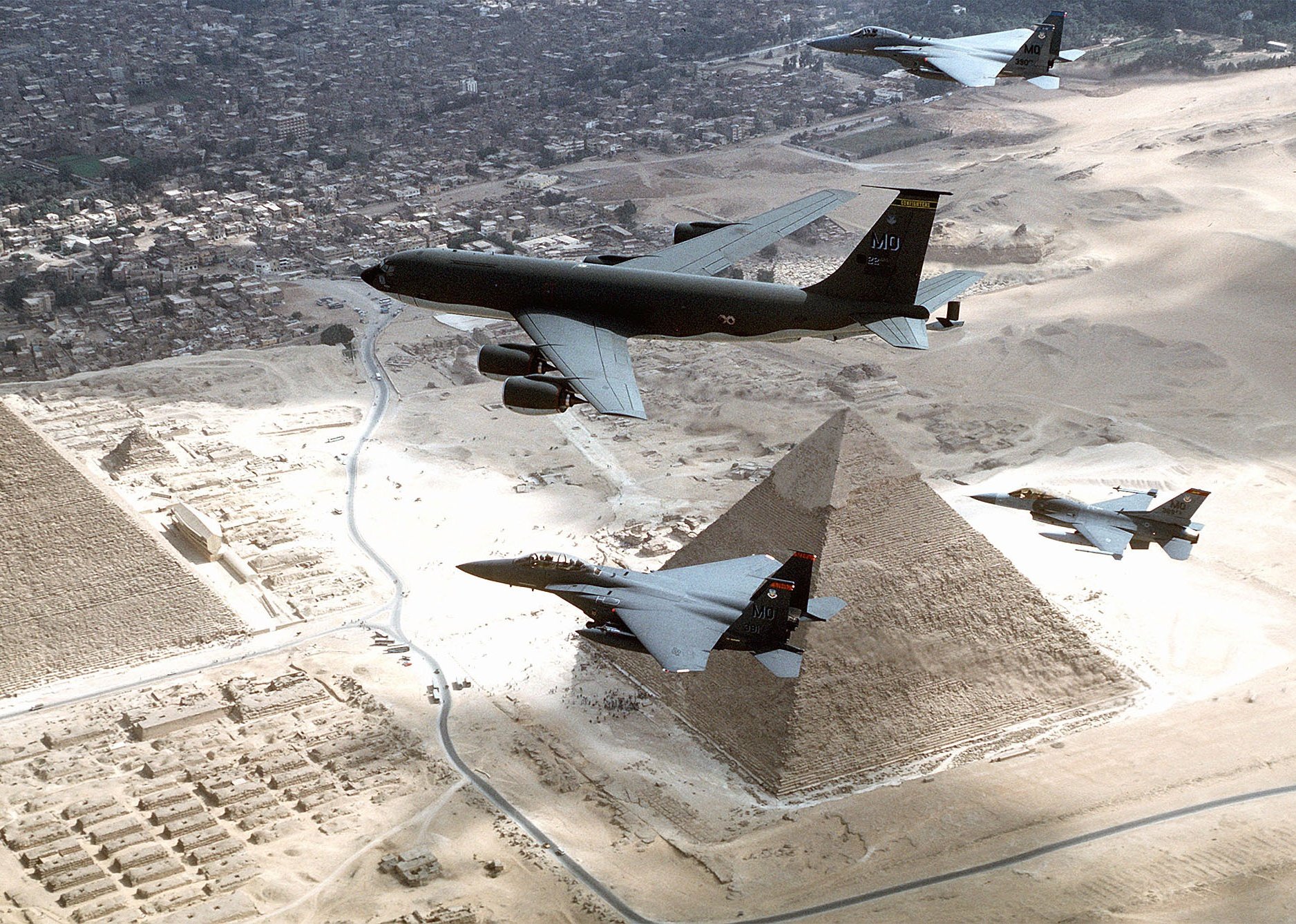 A KC-135R, F-15's and a F-16 fly over the pyramids of Egypt. 