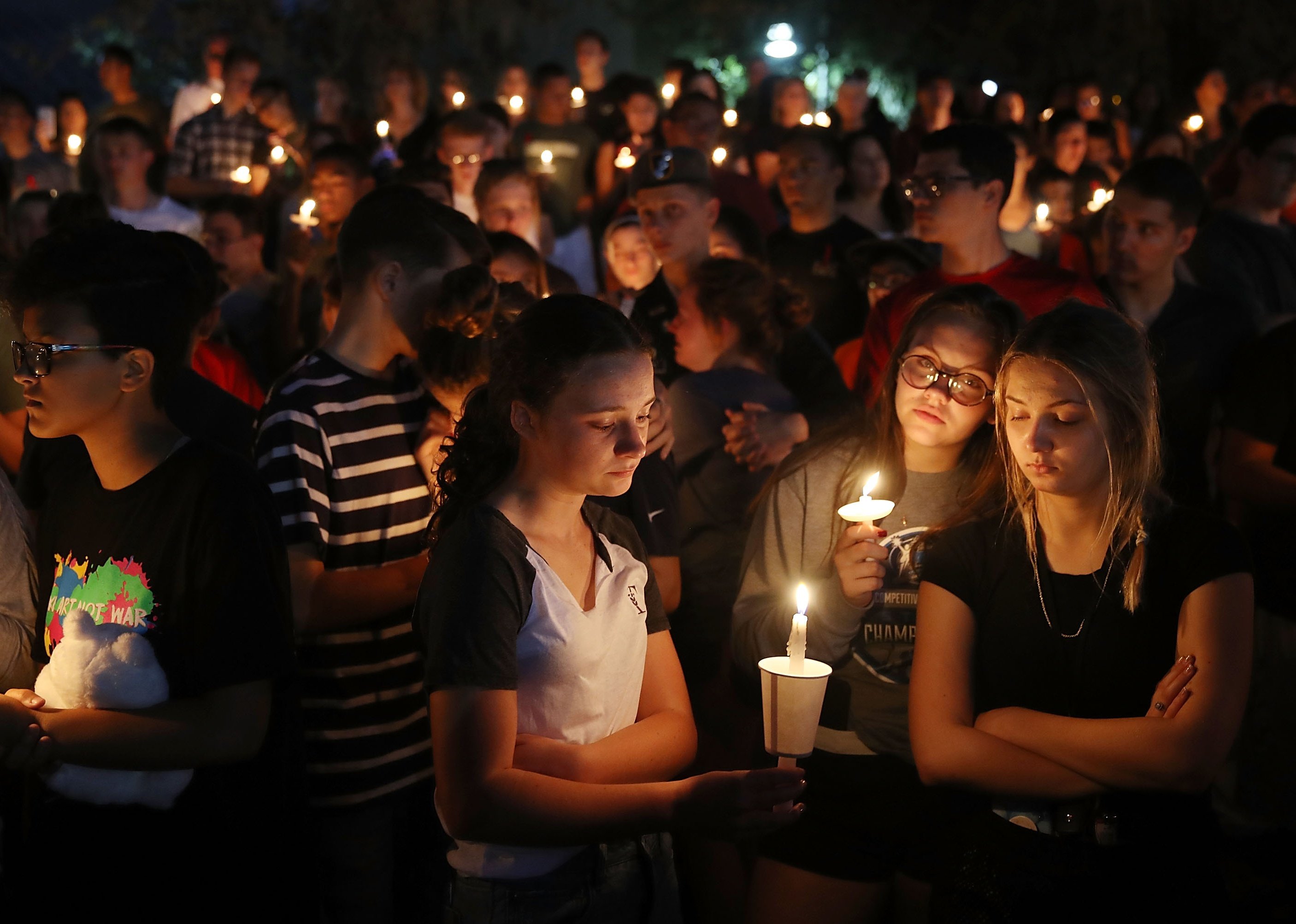 People attend a memorial service for the victims of the shooting at Marjory Stoneman Douglas High School.