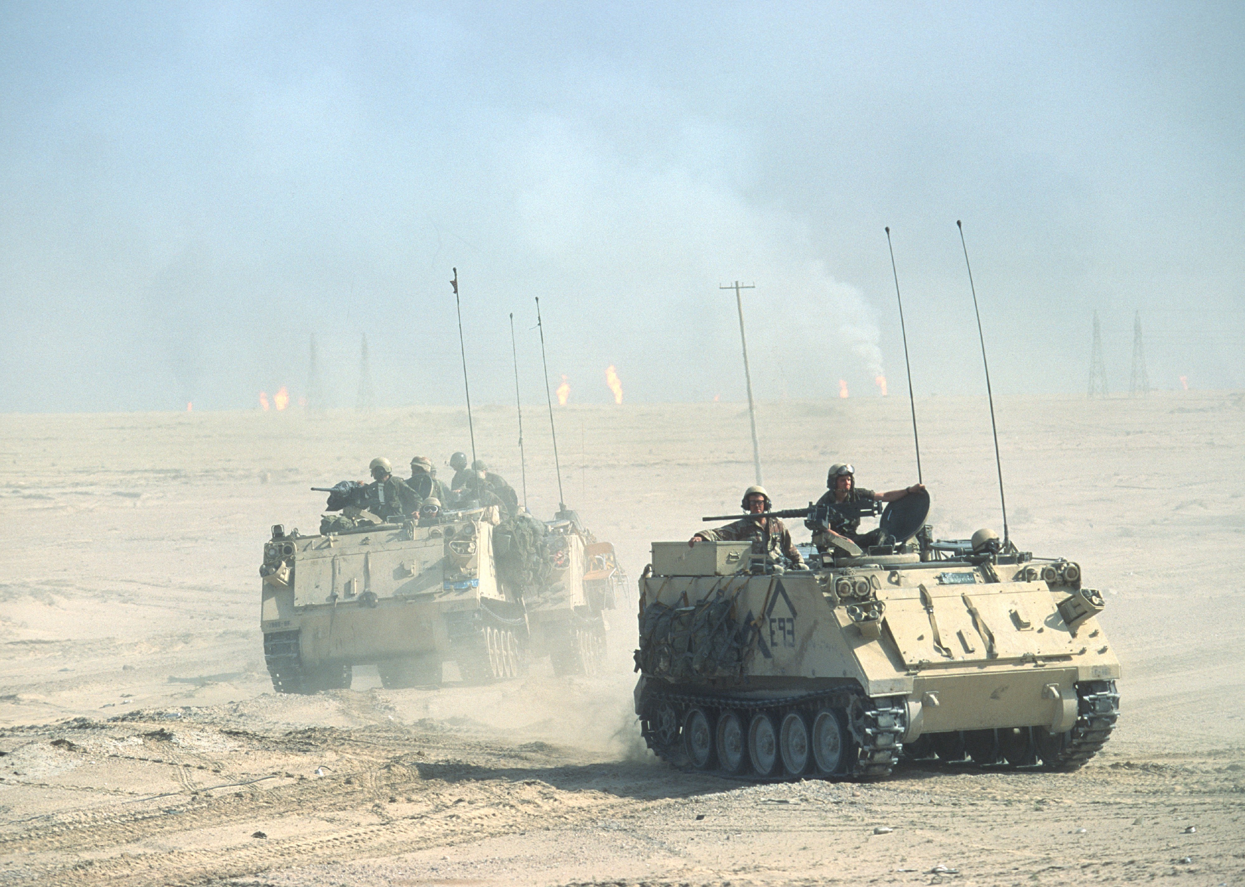 American M113 Armored Personnel Carriers as they cross the desert.