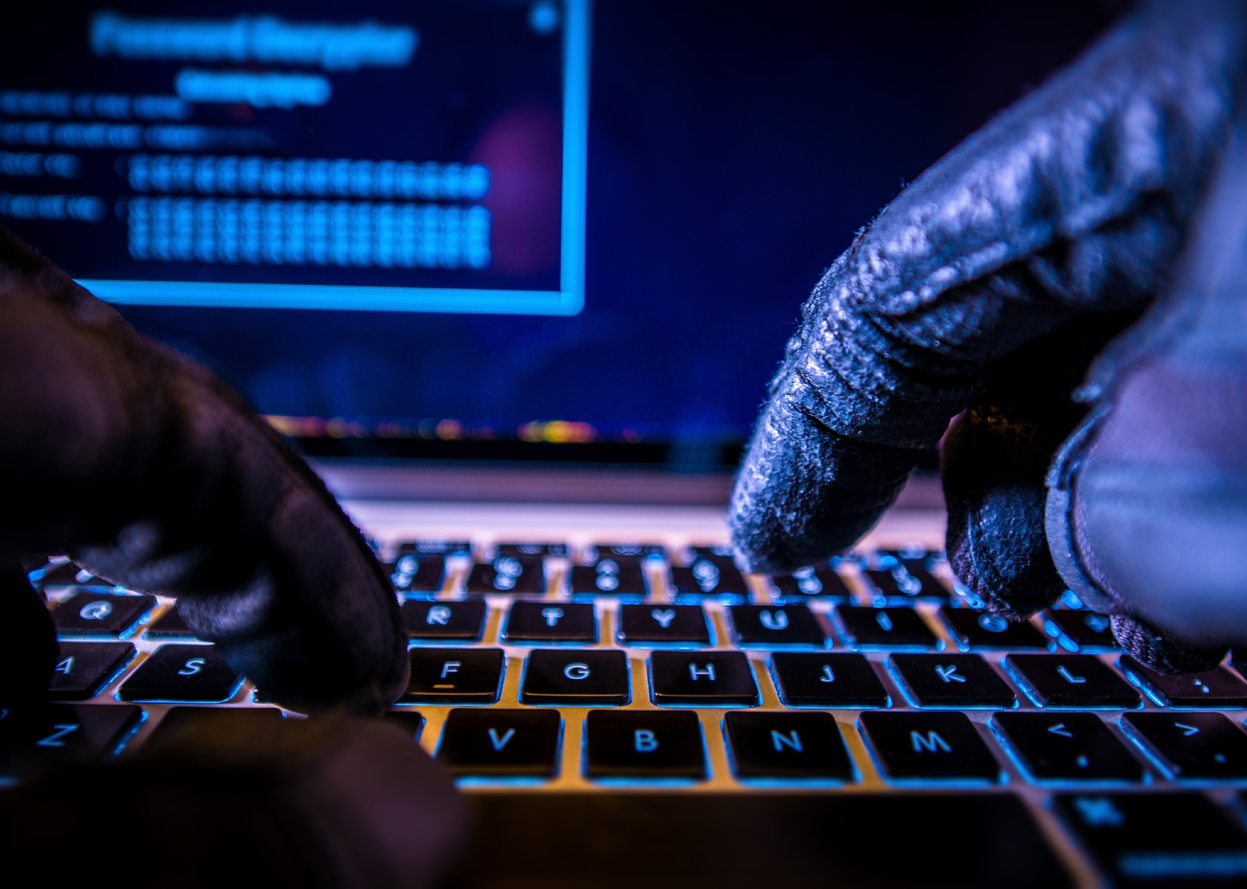  Hacker in black gloves typing