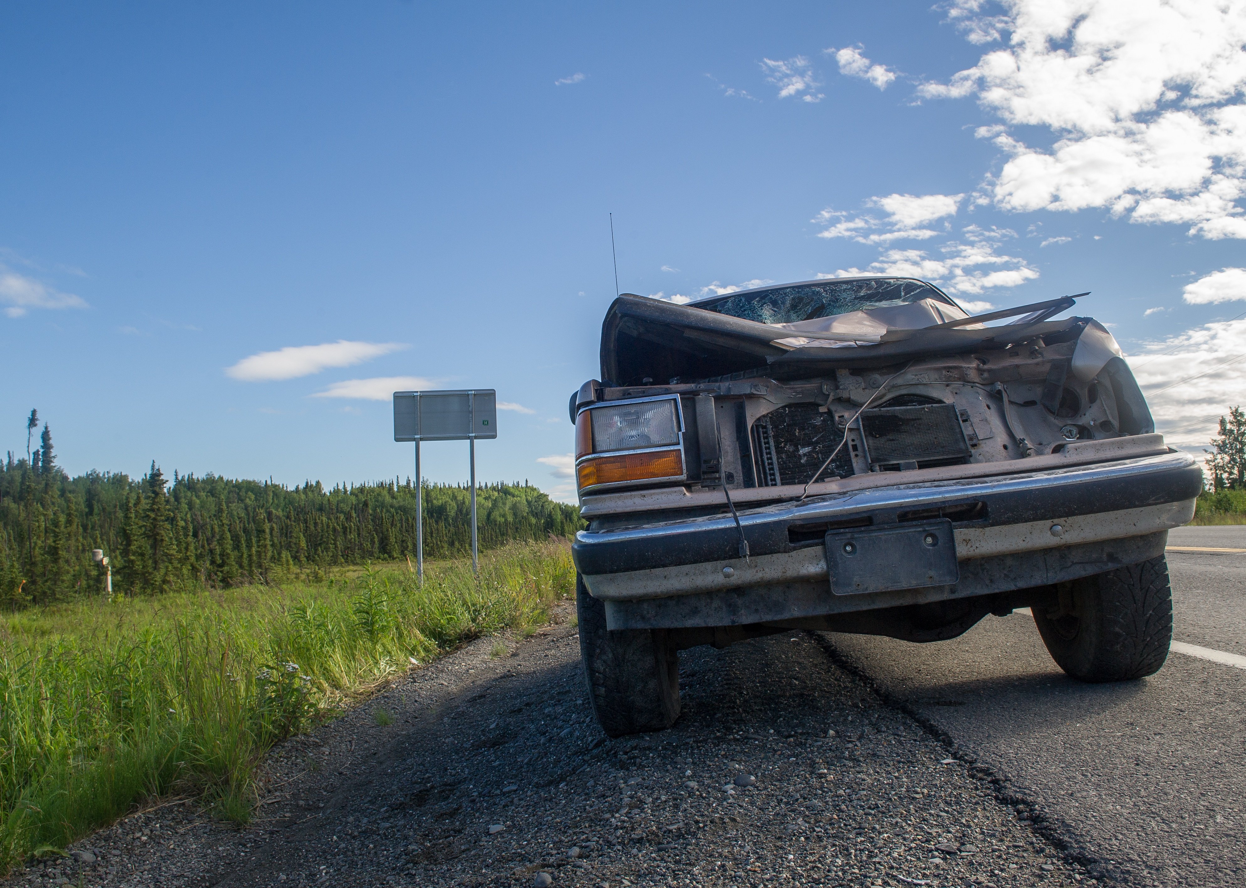 Wrecked car on the side of the road after collision in Alaska.