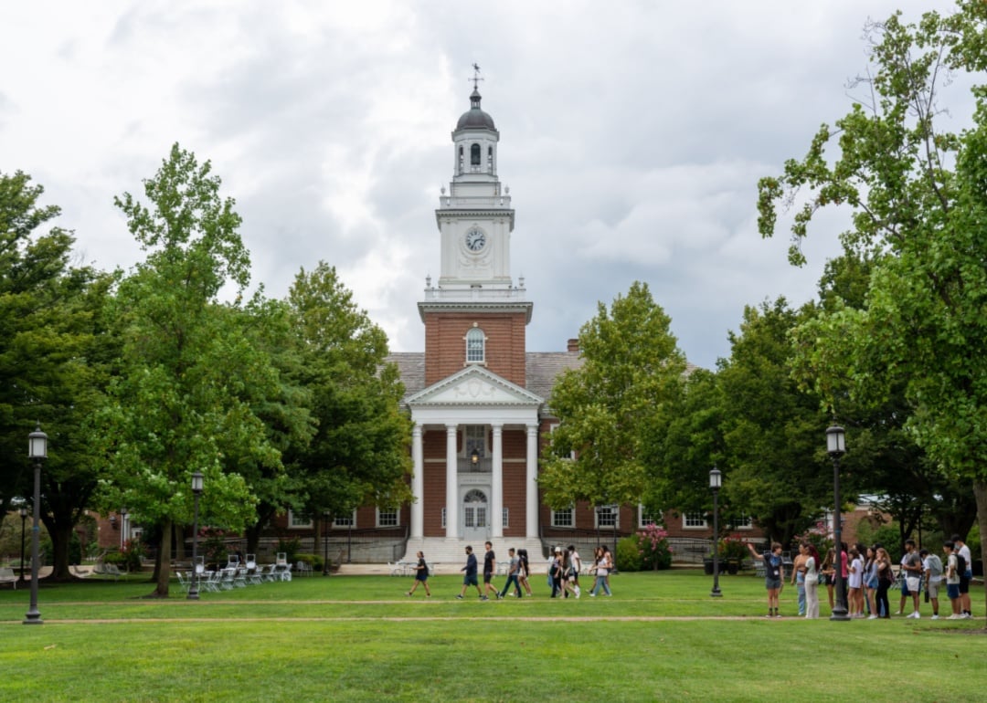 Students walk past Gilman Hall on the Johns Hopkins University campus.