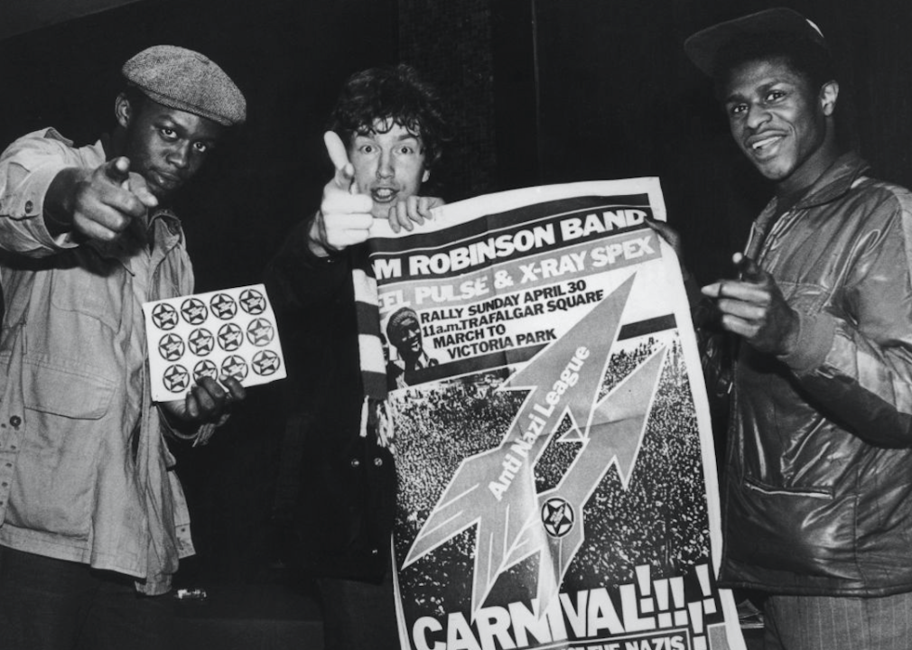 Tom Robinson Band holding poster.