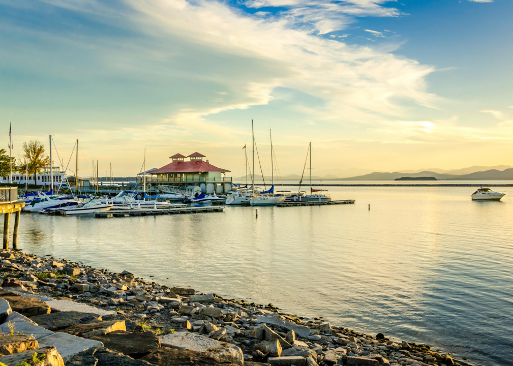 A harbor with boats docked at sunset. 