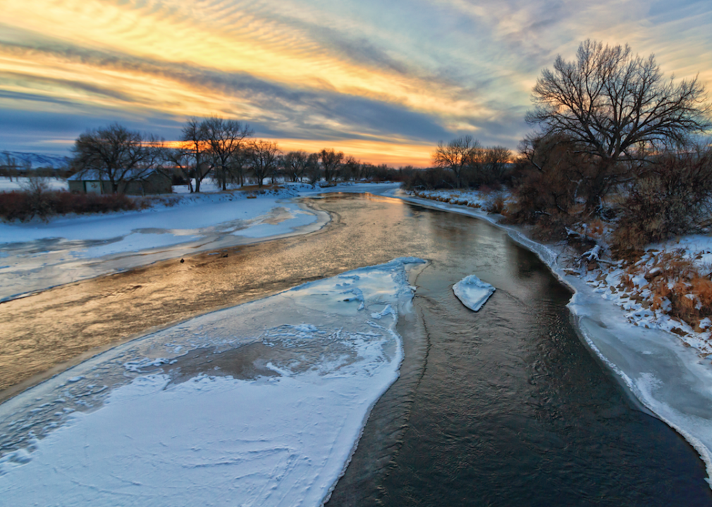 A river with ice and snow at sunset.