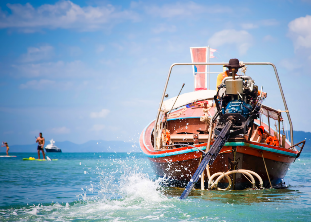 A motorboat operator steers his watercraft.