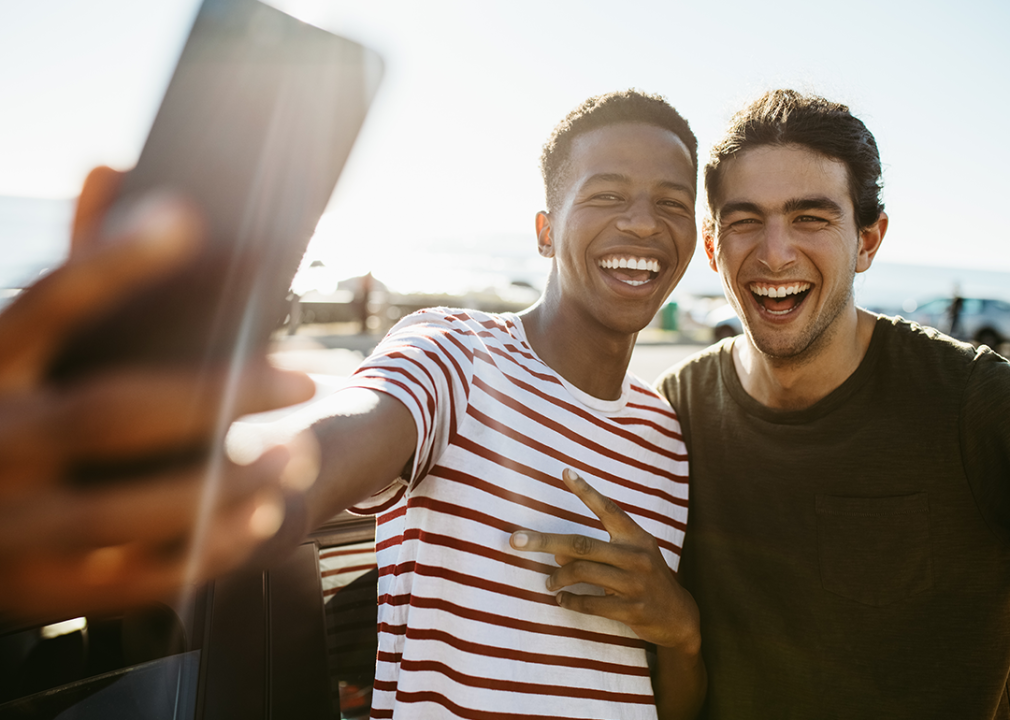 Two men taking selfie on rooftop.