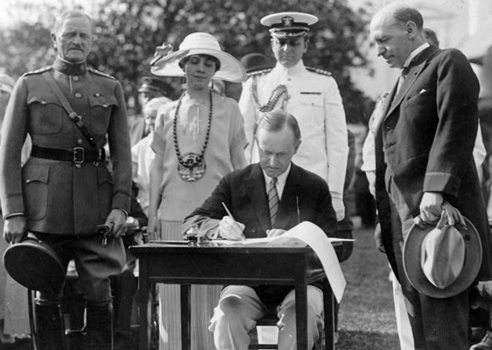 Calvin Coolidge signing the Veterans' Bill on the White House Lawn.