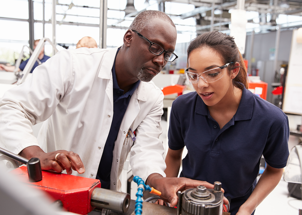 Engineer showing equipment to an apprentice.