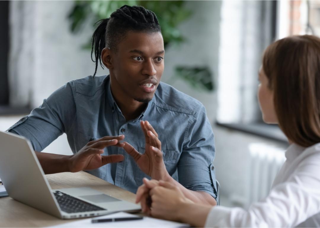 Tech manager discusses systems with coworker.