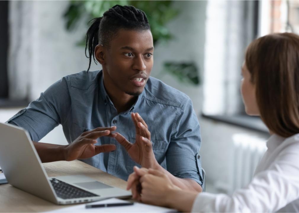 Tech manager discusses systems with coworker.