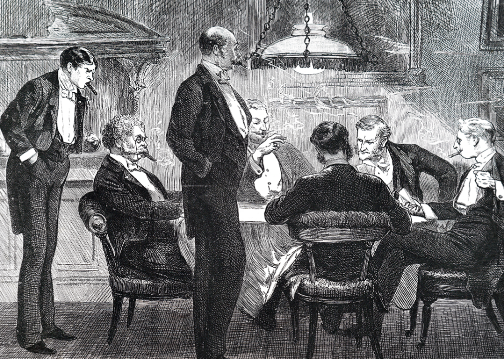 Engraving showing men at a card table smoking cigars and playing cards.