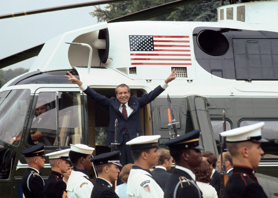 Richard Nixon in helicopter giving “V” sign after resignation.