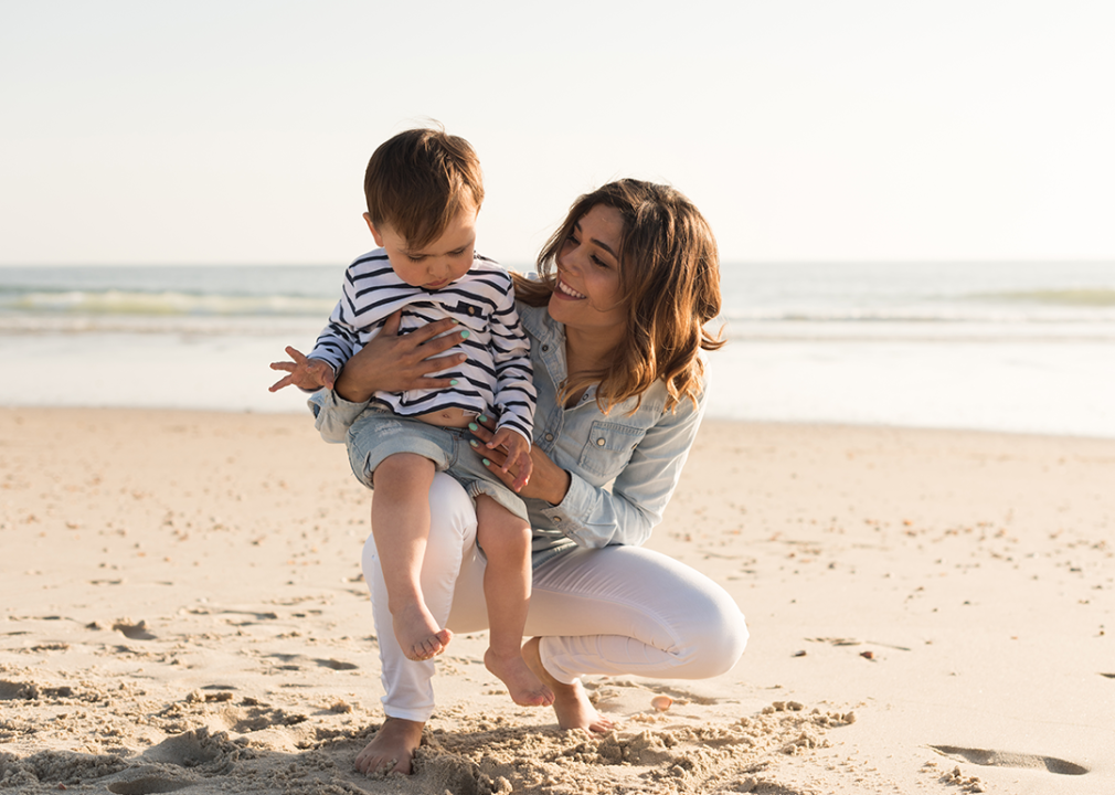 Mother exploring the beach with her baby.