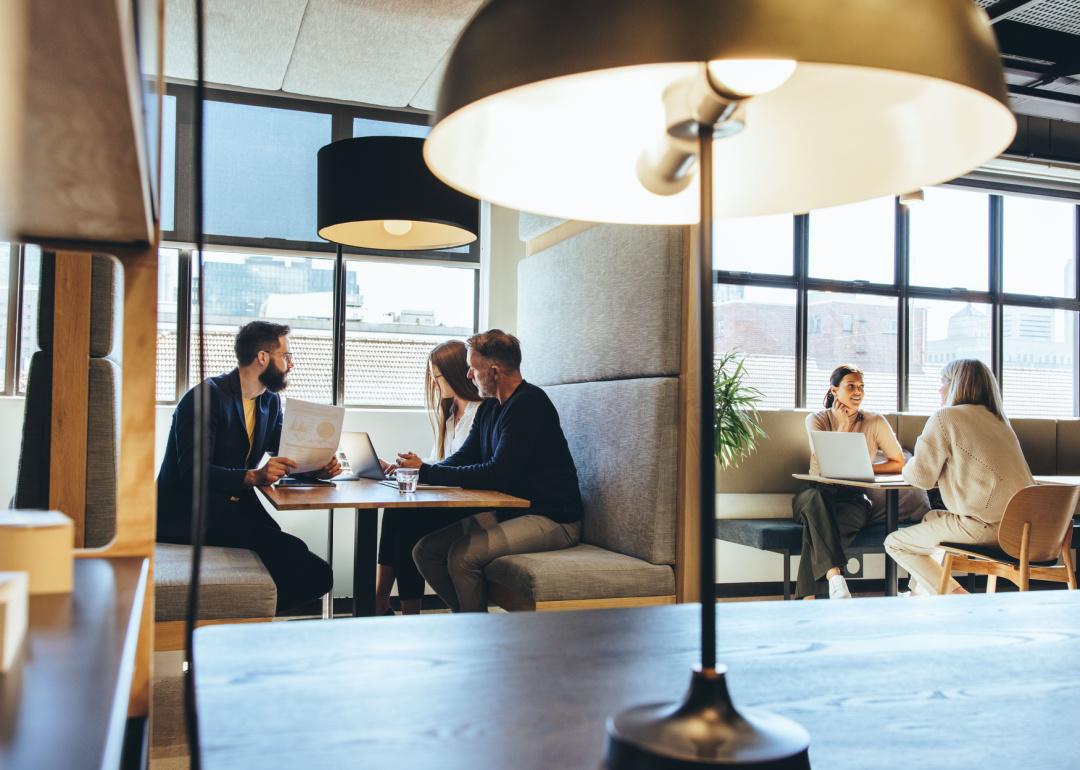 Professionals having discussions in an open workspace.