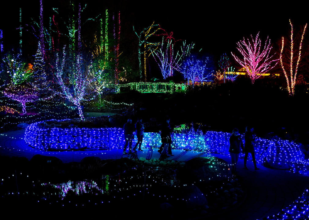 People walk through an illuminated pathway in Boothbay.