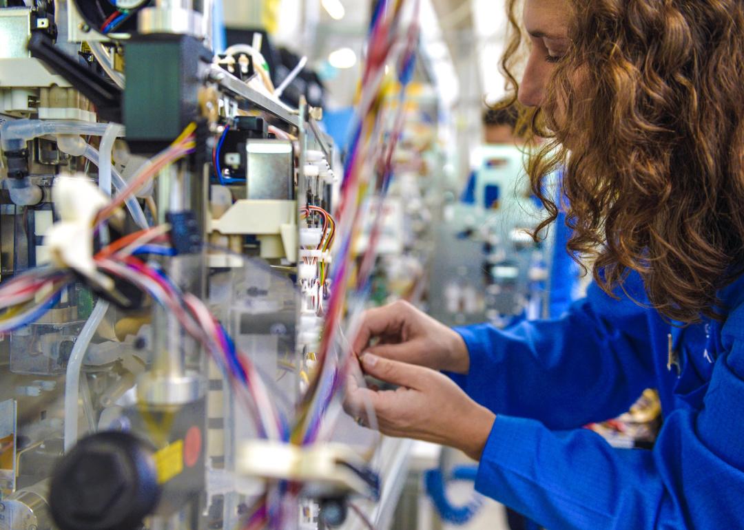 Closeup of woman on factory assembly line.