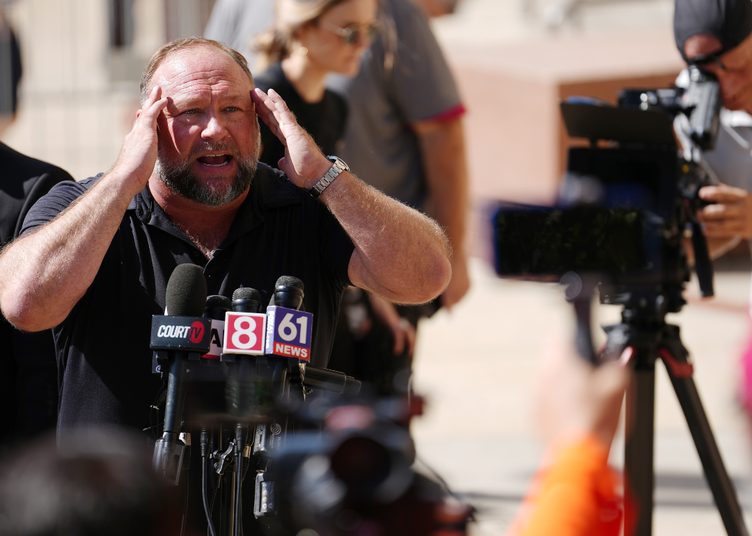 Alex Jones speaks to the media during trial