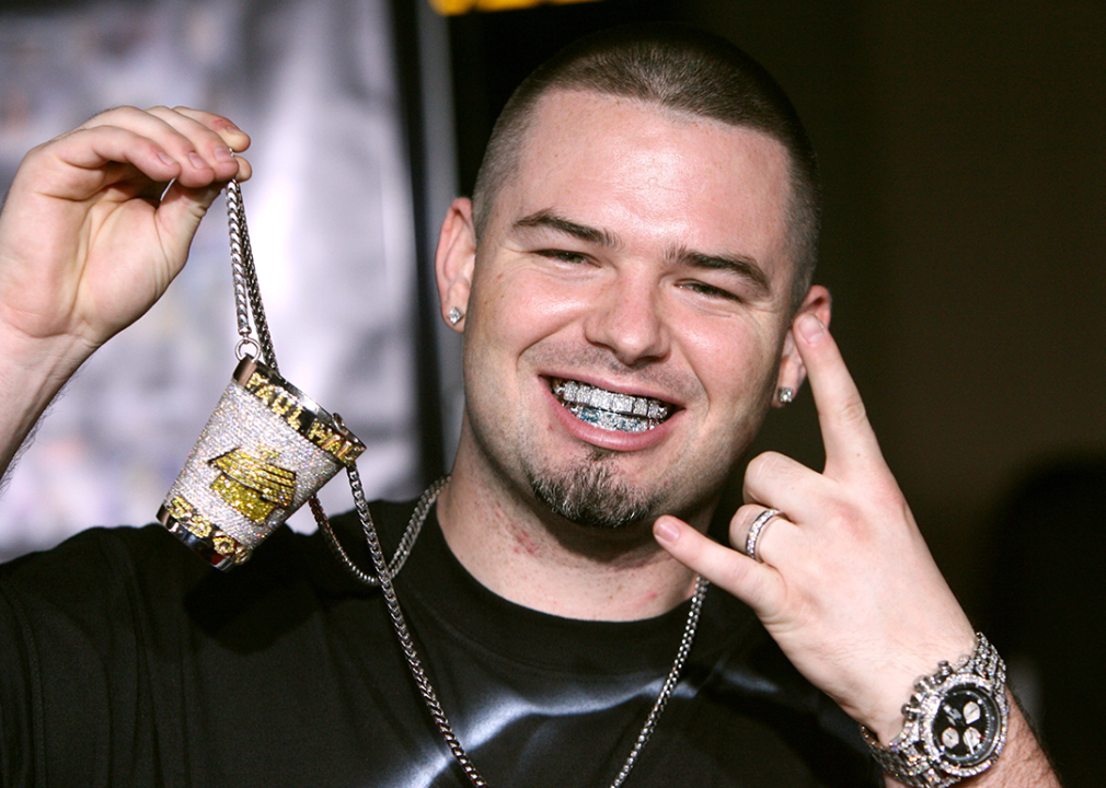 Paul Wall poses with jewelry for photographers at BET 25th Anniversary Show.