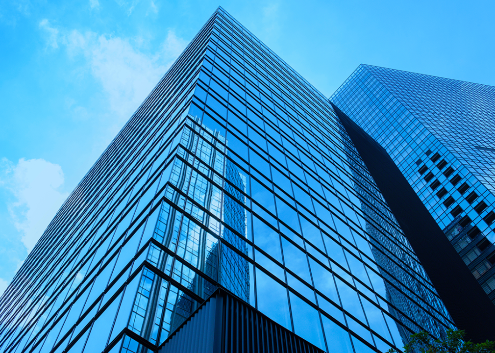 Large corporate office buildings reflecting blue sky.