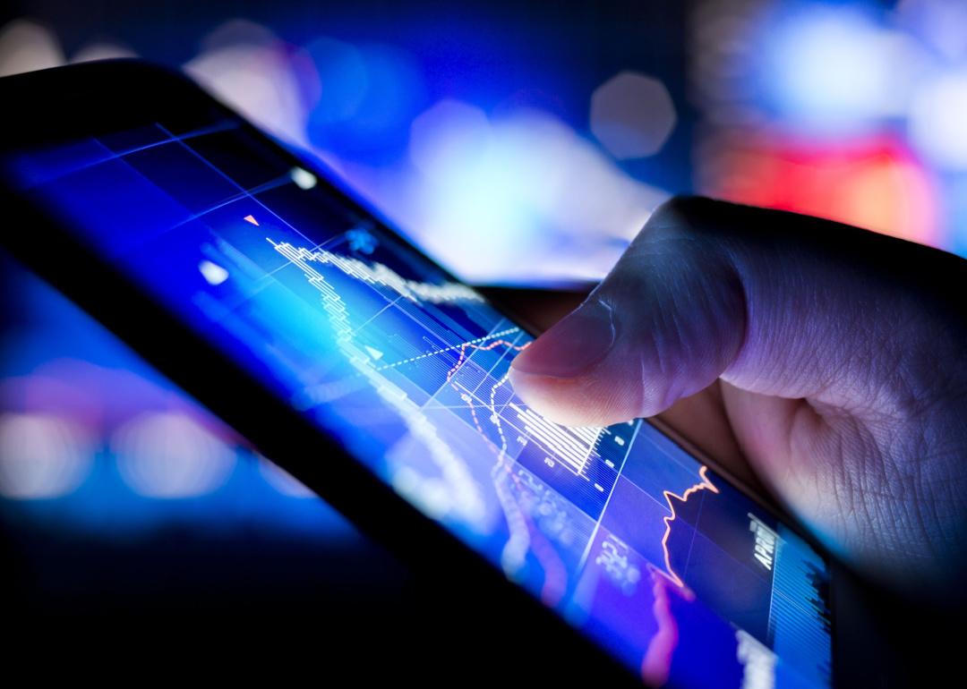 Person checking financial charts on phone
