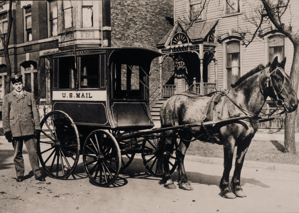 Postman delivers mail by horsedrawn carriage