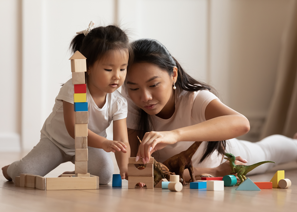 Mother and child playing with blocks.