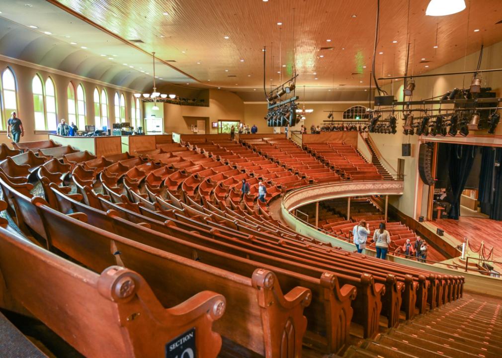 Interior of Ryman Auditorium with curved wooden seats.