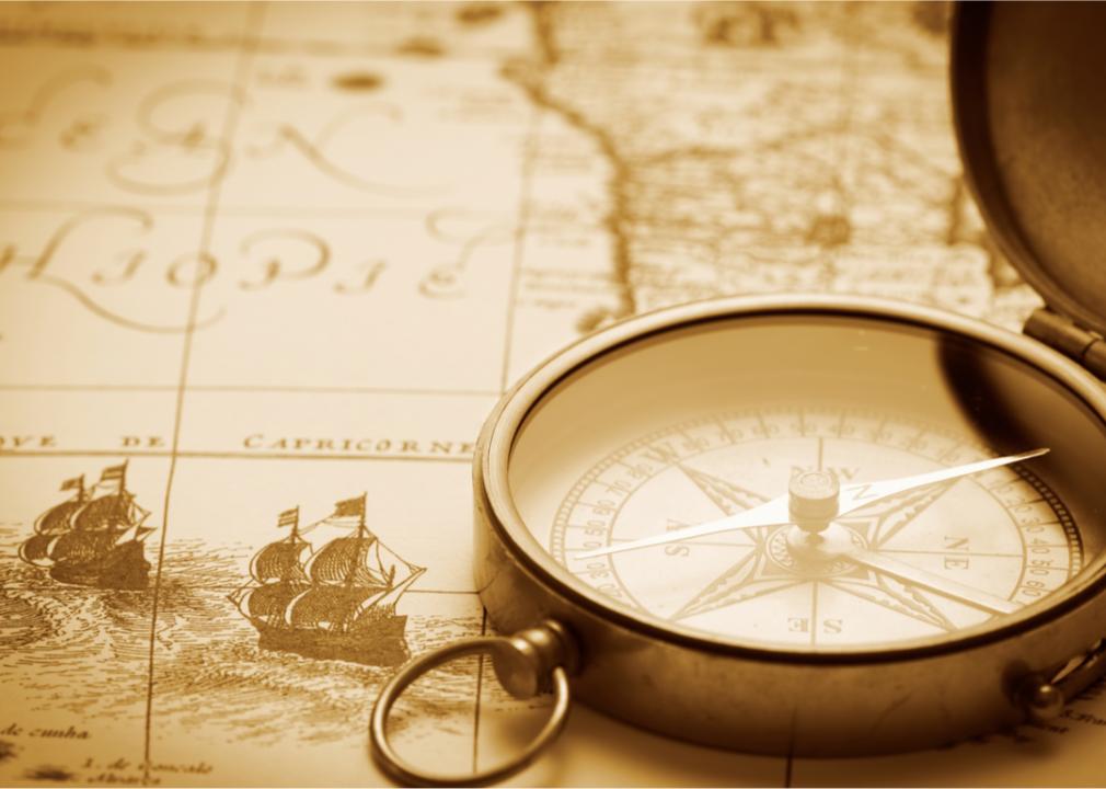 A picture of a vintage map and a magnifying glass. 