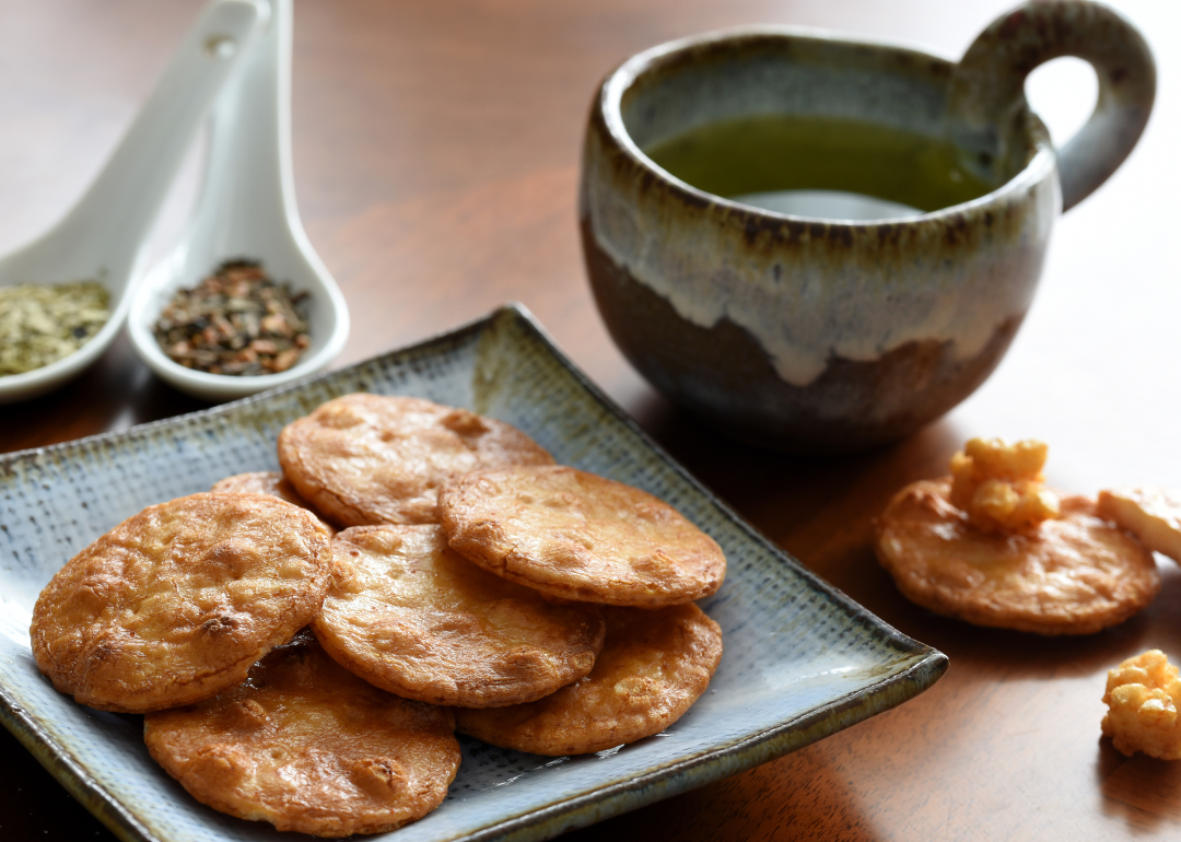 Sesame crackers on plate with tea setting.