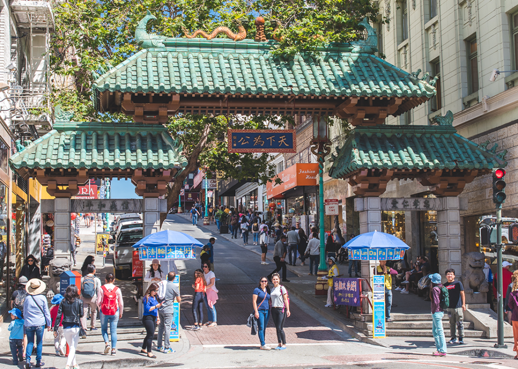 People pose for photos by the Chinatown Gate in San Francisco.